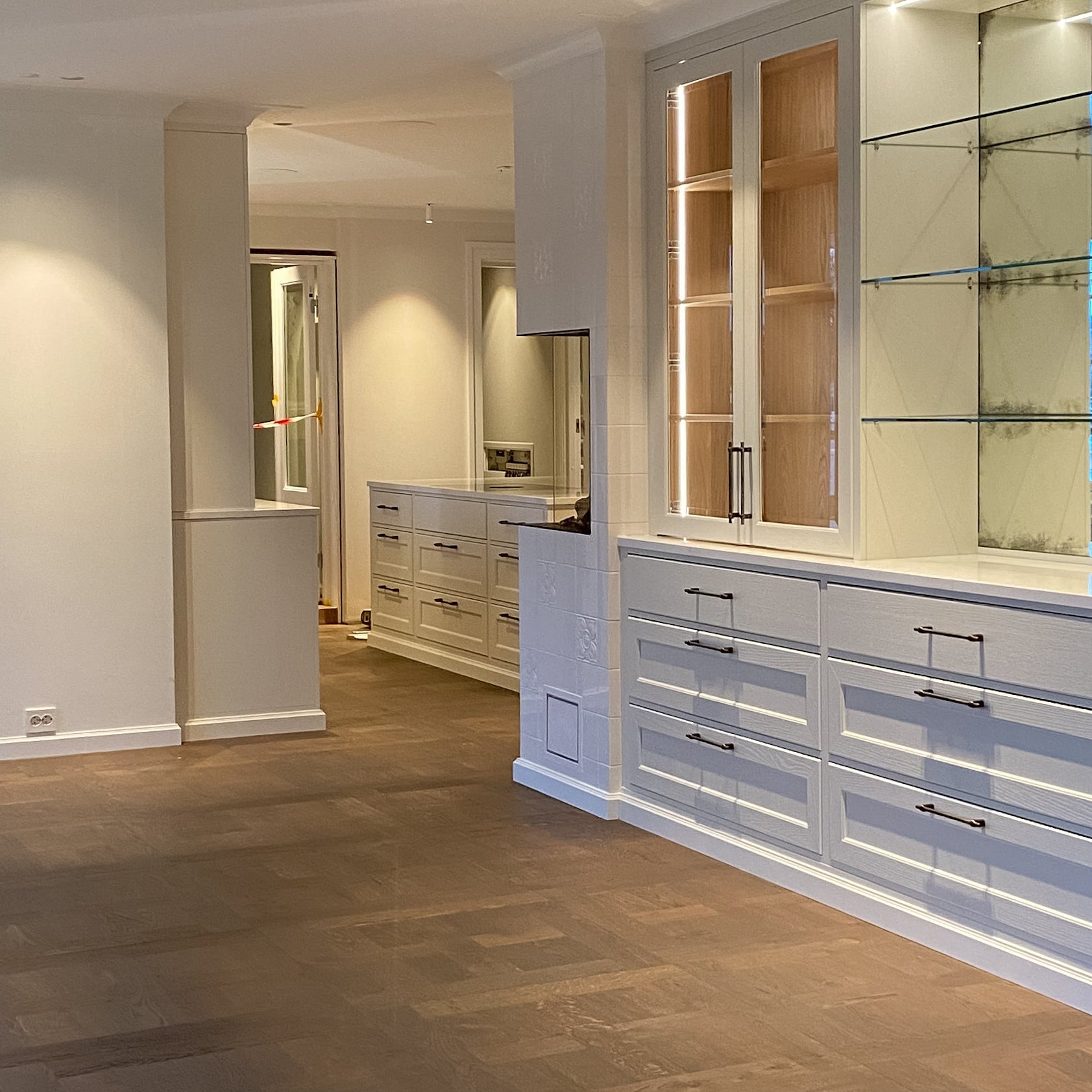 Modern interior with wooden flooring and built-in cabinets.
