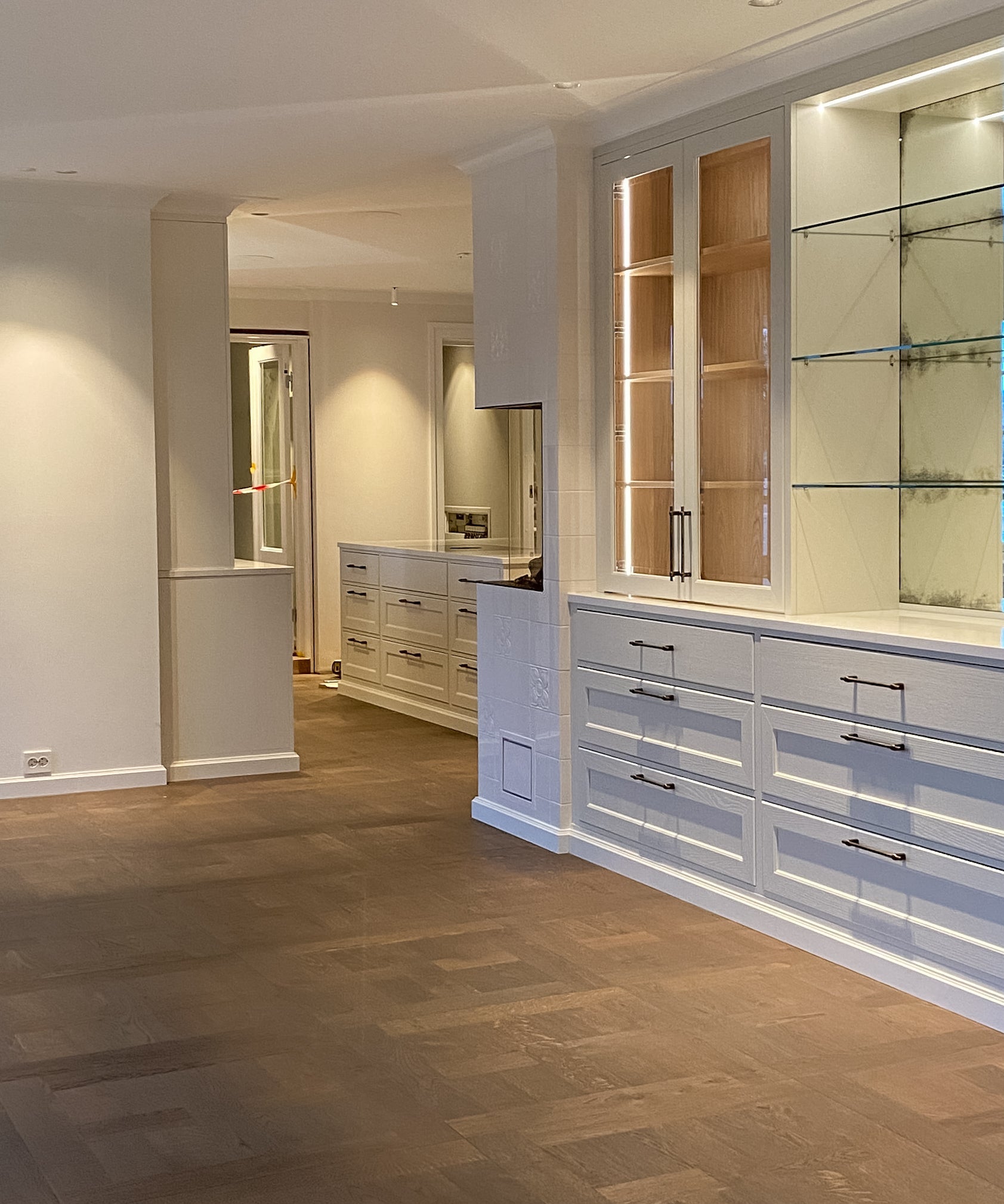Modern interior with wooden flooring and built-in cabinets.