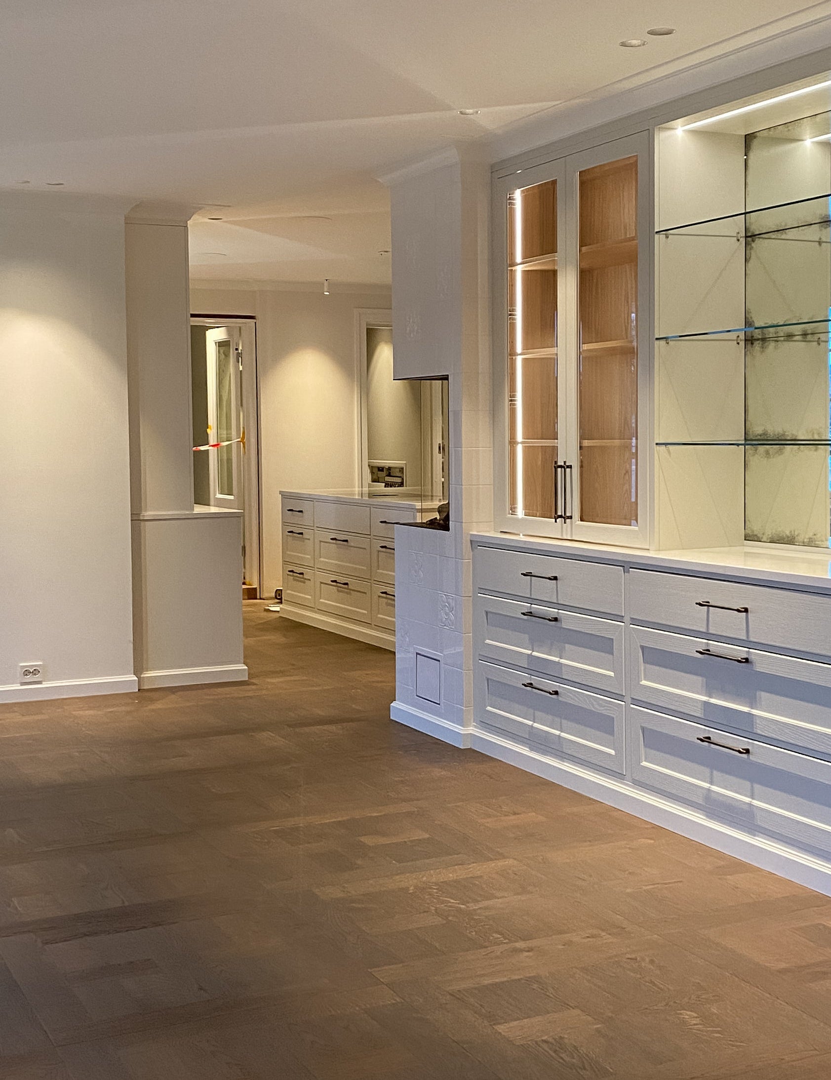Modern interior with wooden flooring and built-in cabinets.